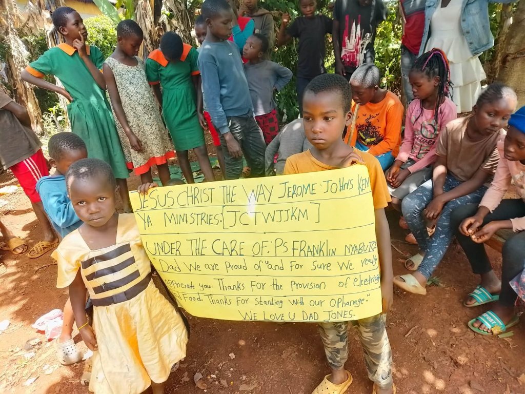 The children of Pastor Frankline's ministry with a thank-you sign for Jerome Jones Ministries