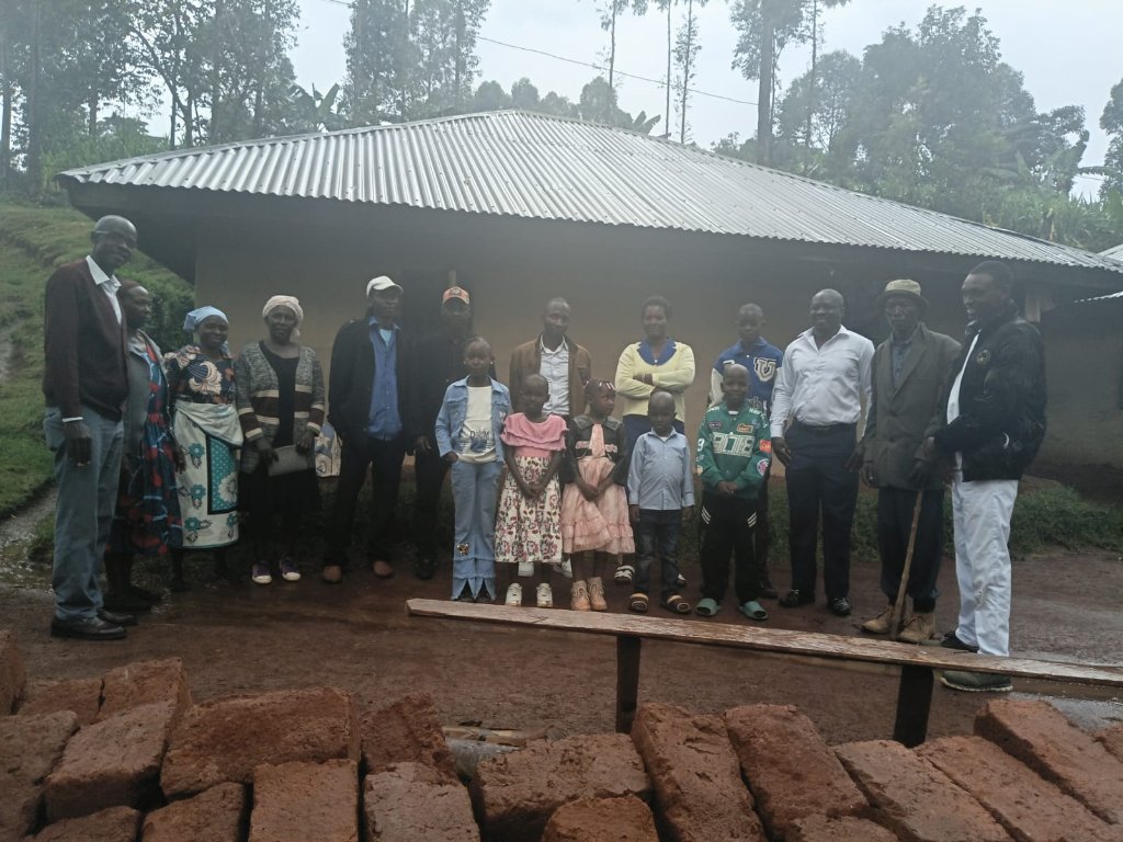 The ministry community gathered near a building project