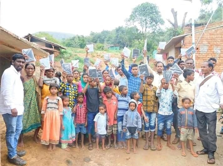 A village in India lifting new Bibles together