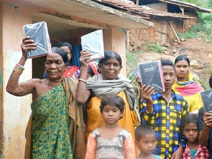 Women of India raising their Bibles high